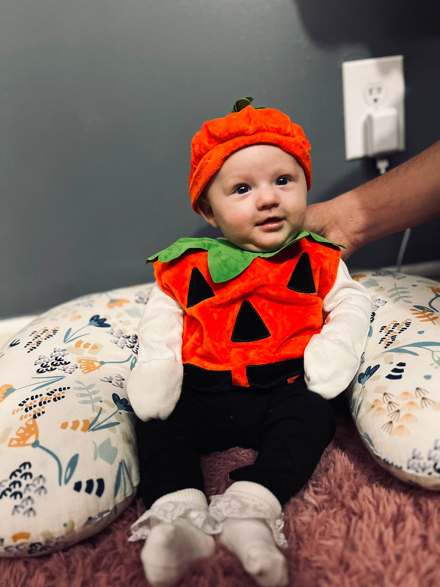 Sadie is registered to the contest to win money with this photo: baby, baby_toddler_clothing, calabaza, child, costume, costume_hat, fictional_character, fun, fur, happy, hat, headwear, orange, pattern, person, personal_protective_equipment, pumpkin, room, sitting, sleeve