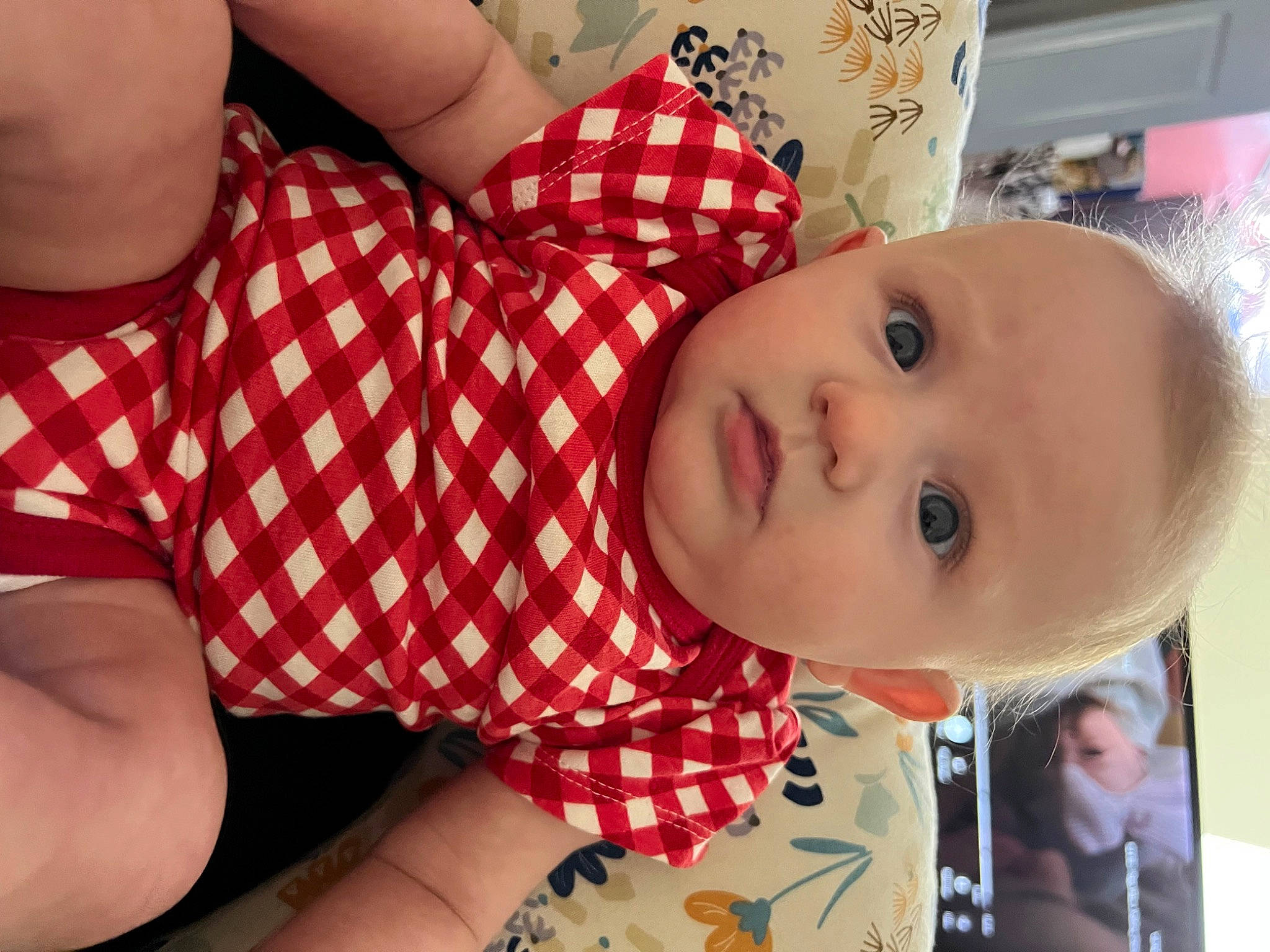 Sadie Mae is registered to the contest to win money with this photo: abdomen, baby, baby_toddler_clothing, cheek, chest, child, comfort, elbow, eyelash, happy, human_leg, lip, mouth, nose, pattern, person, plaid, skin, textile, thigh