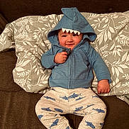 Hylandis is registered to the contest to win money with this photo: baby, clothing, coat, couch, cushion, face, furniture, hat, head, homedecor, hood, hoodie, knitwear, pajamas, pants, person, photography, portrait, sweater, sweatshirt