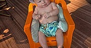 Wesley joined the competition — help win amazing prizes! baby, carpet, casual, child, clothing, comfort, cushions, floor, hat, home, indoor, orange_chair, person, plastic_chair, relaxation, seated, shadow, shorts, stroller, sunlight