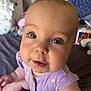 Poppy joined the competition — help win amazing prizes! baby, infant, child, purple_clothing, blue_eyes, close_up, indoor, bed, blanket, soft_toys, bottle, cute, person, smiling, sitting, hand, face, skin, young, curious