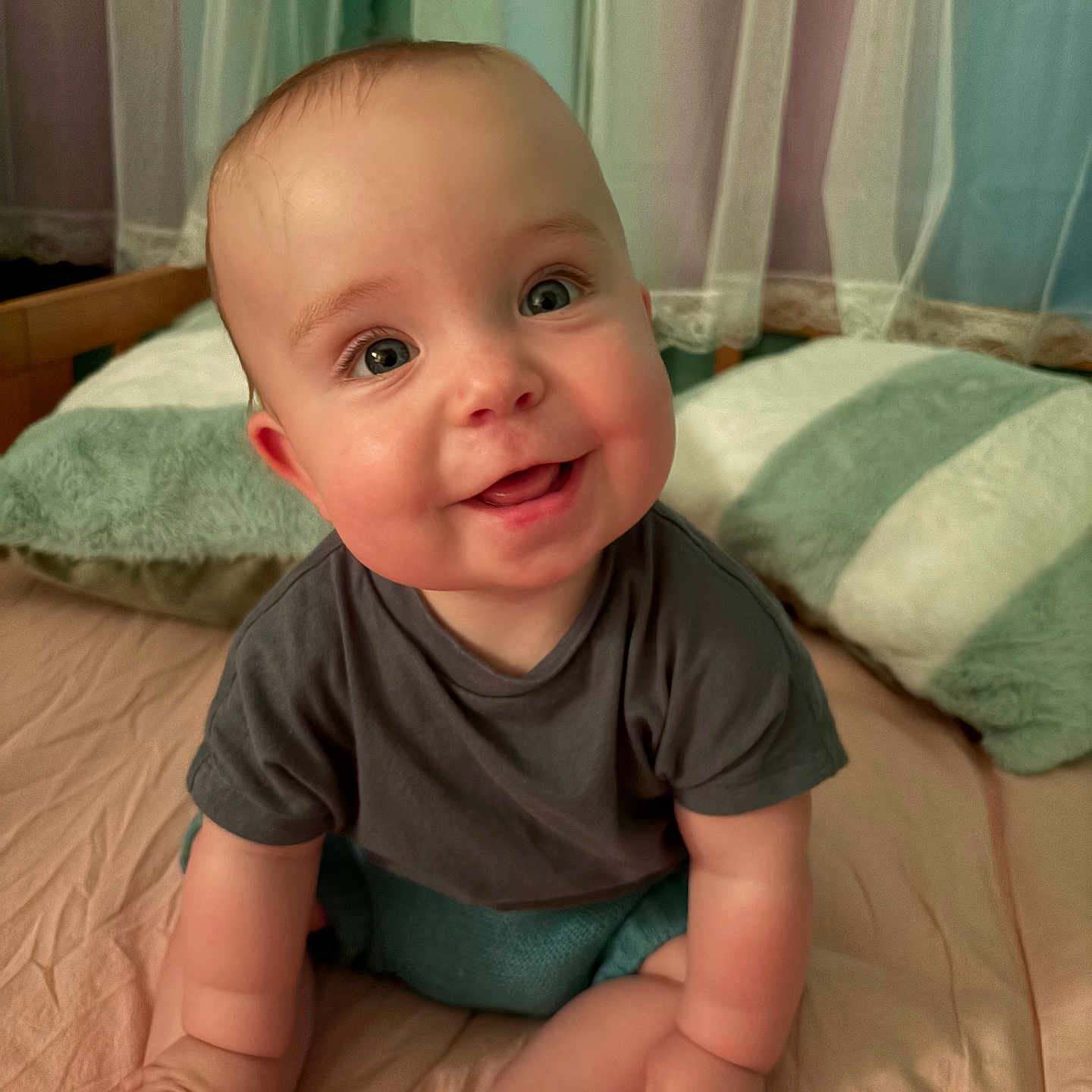 Poppy is registered to the contest to win money with this photo: baby, bed, child, clothing, cozy, curtain, cute, eyes, face, feet, hands, happy, indoors, infant, pillow, portrait, sitting, skin, smile, soft