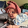 Poppy is registered to the contest to win money with this photo: baby, infant, child, towel, bed, blanket, blue_mushroom_pattern, clothing, smiling, happy, skin, hand, face, indoors, soft_light, cozy, cute, person, lying_down, playful