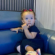 Lya participe au concours pour gagner de l'argent avec cette photo : blue_couch, casual_clothing, child, contemplative, curly_hair, cute, fashion, girl, hair_ties, indoor, leather_couch, modern_interior, navy_dress, person, pink_shoes, portrait, seated, small_shoes, toddler, young_child