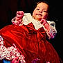 Angel participe au concours pour gagner de l'argent avec cette photo : baby, child, dress, red_dress, lace, bow, infant, portrait, smiling, cute, hands, feet, clothing, person, studio, dark_background, cute_baby, happy, celebration, holiday
