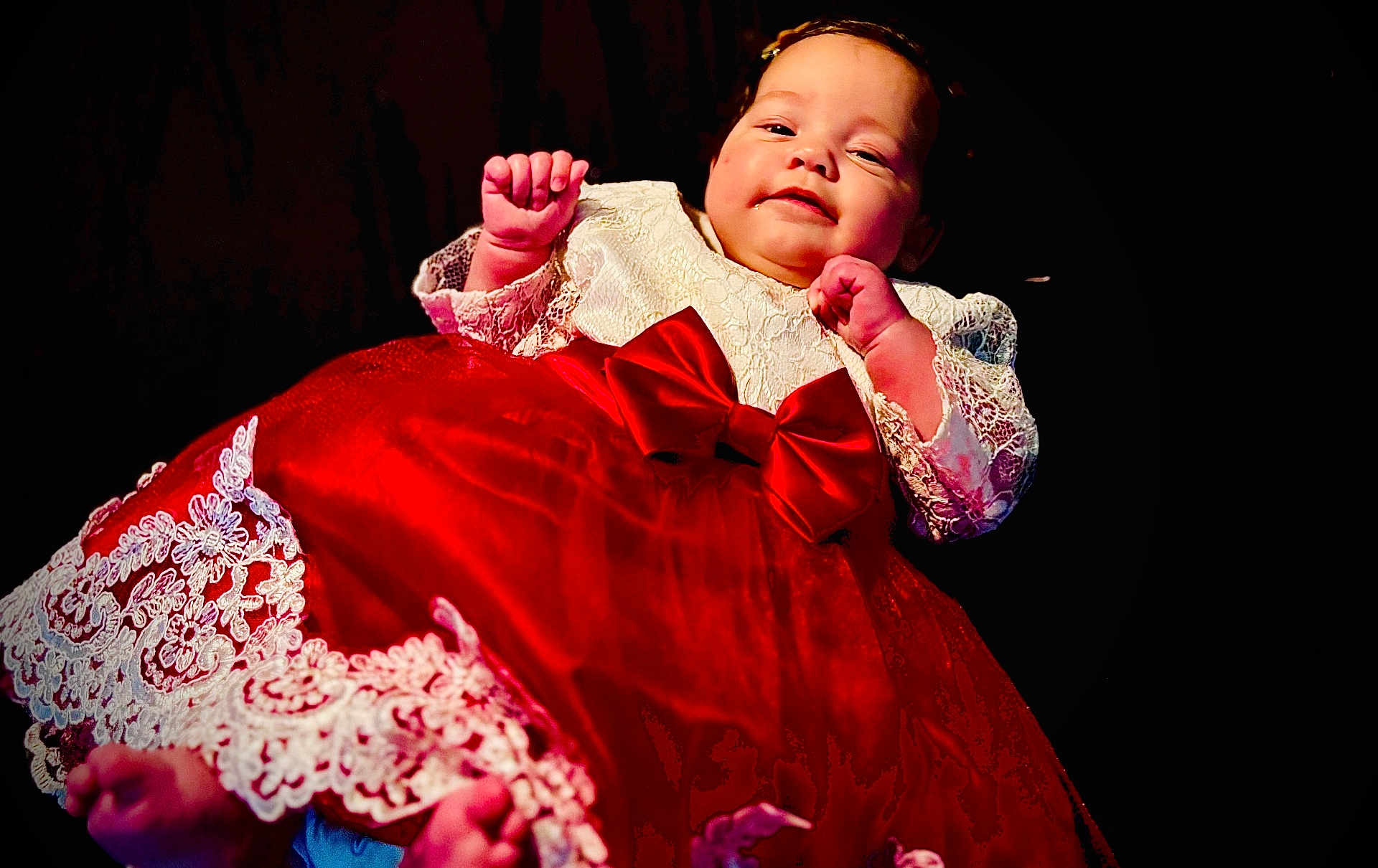 Angel participe au concours pour gagner de l'argent avec cette photo : baby, child, dress, red_dress, lace, bow, infant, portrait, smiling, cute, hands, feet, clothing, person, studio, dark_background, cute_baby, happy, celebration, holiday