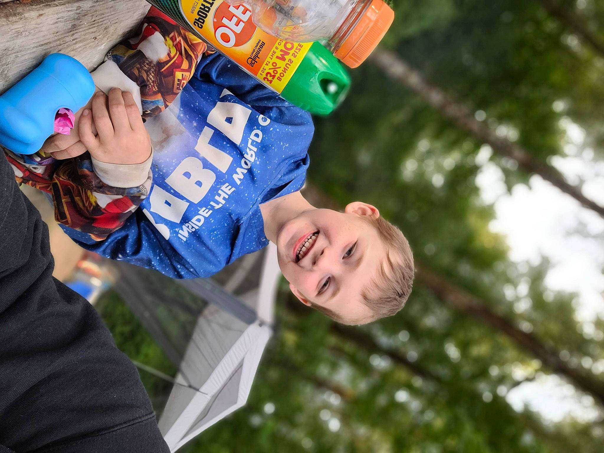 Mayson is registered to the contest to win money with this photo: child, event, fun, gesture, grass, happy, hat, joy, leisure, people_in_nature, person, plant, public_event, recreation, suit, tree