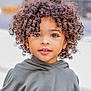 child, curly_hair, face, eyes, hoodie, smile, portrait, young, cute, outdoor, person, fashion, expression, skin, childhood, casual_clothing, hair, closeup, innocence, happy
