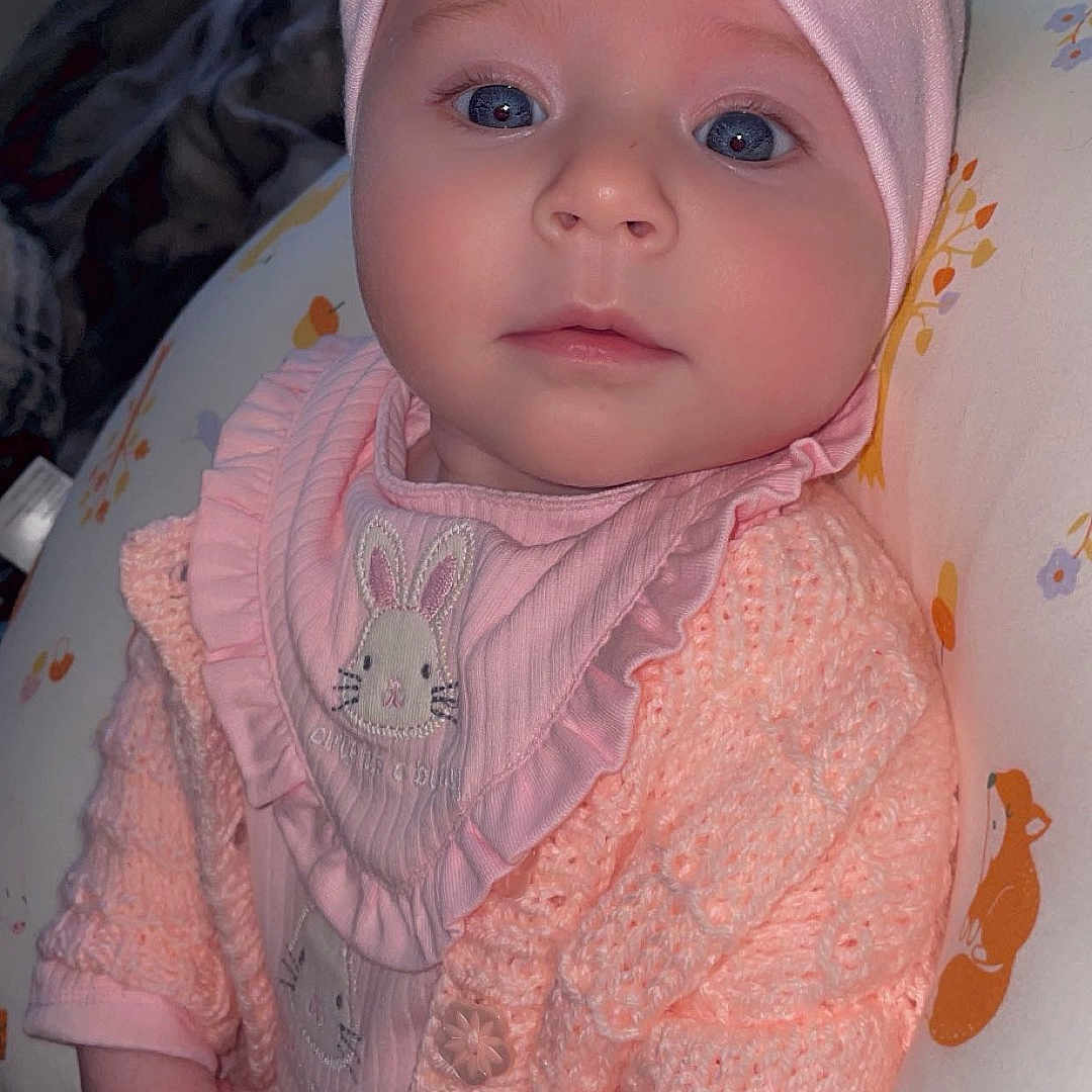 Luna-Skye is registered to the contest to win money with this photo: accessories, baby, bonnet, cap, clothing, coat, costume, dress, face, hat, head, hoodie, jacket, knitwear, newborn, pants, person, photography, portrait, sweater