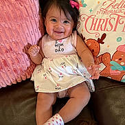 Amairani joined the competition — help win amazing prizes! baby, brown, child, clothing, couch, cute, dress, face, hair_bow, happy, holiday, indoors, infant, pillow, pink, portrait, sitting, smiling, sock, white