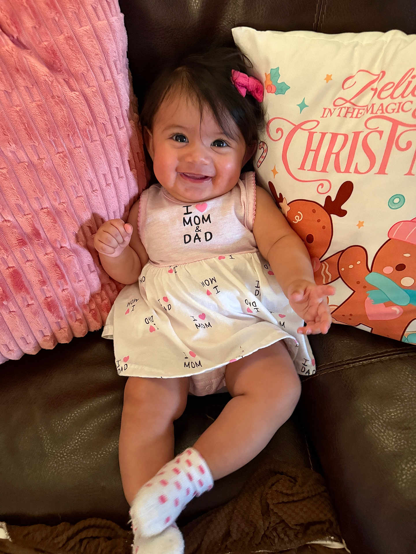 Amairani joined the competition — help win amazing prizes! baby, brown, child, clothing, couch, cute, dress, face, hair_bow, happy, holiday, indoors, infant, pillow, pink, portrait, sitting, smiling, sock, white