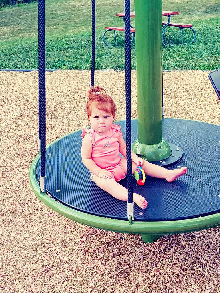 Ivanna joined the competition — help win amazing prizes! baby, baby_toddler_clothing, child, chute, city, electric_blue, fun, grass, green, leisure, outdoor_play_equipment, person, play, playground, playground_slide, public_space, recreation, shorts, sitting, swing