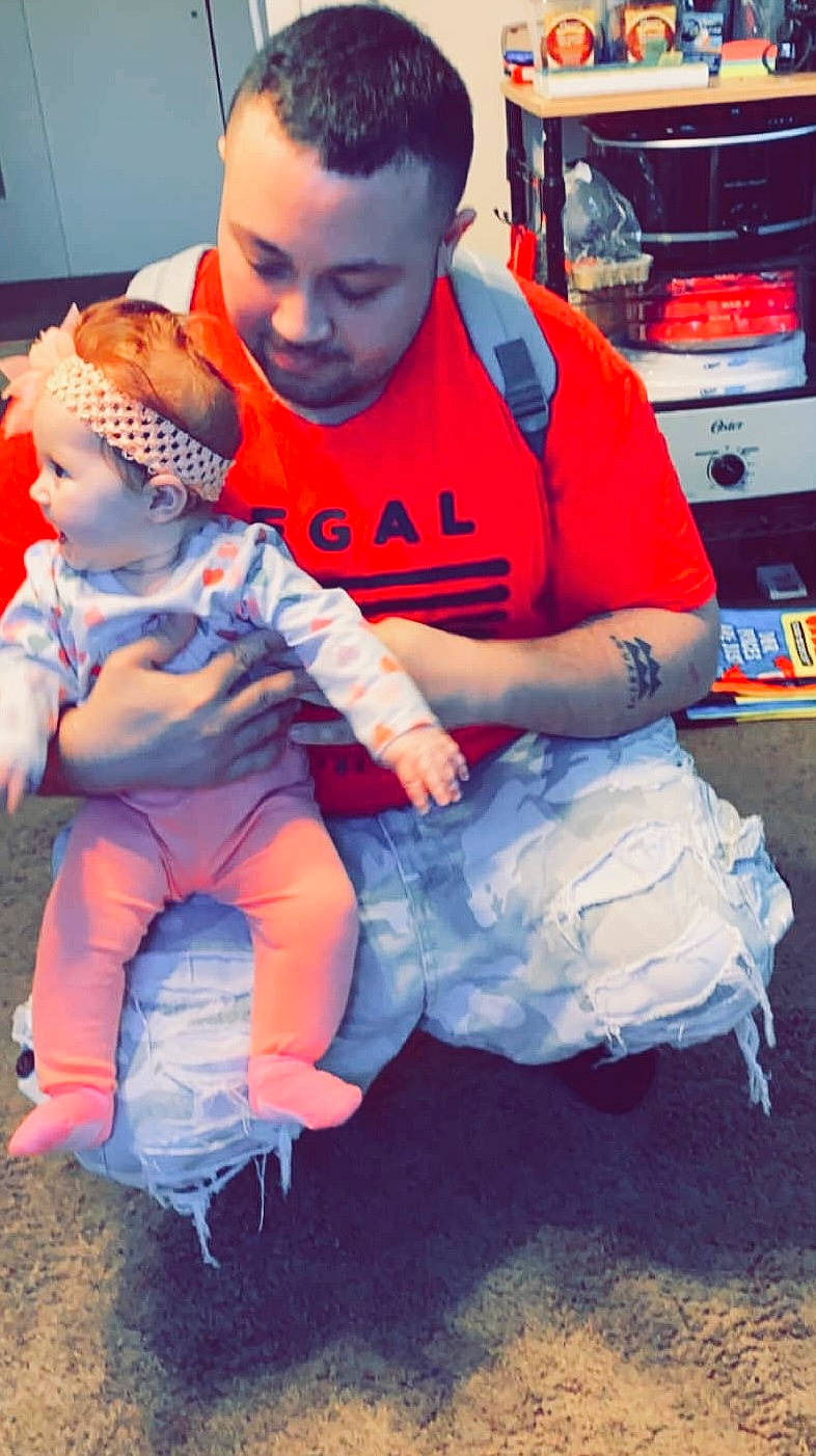 Ivanna is registered to the contest to win money with this photo: baby, baby_toddler_clothing, child, costume, electric_blue, event, face, fictional_character, fun, happy, hat, lap, leg, leisure, person, personal_protective_equipment, service, sitting, t_shirt, toddler