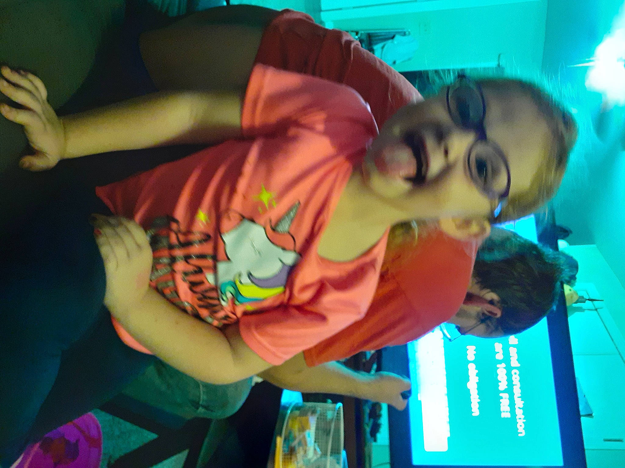 Allianna is registered to the contest to win money with this photo: child, elbow, event, eyewear, fun, green, happy, leisure, light, person, room, sleeve, snapshot, t_shirt, tableware