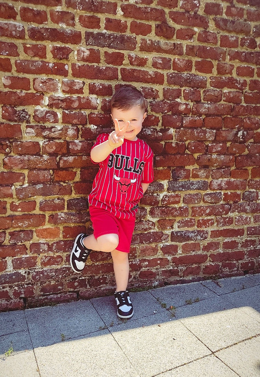 Emilio participe au concours pour gagner de l'argent avec cette photo : asphalt, brick, brickwork, concrete, electric_blue, flash_photography, flooring, happy, human_leg, knee, leisure, pattern, person, road_surface, shorts, sitting, sneakers, standing, t_shirt, toddler