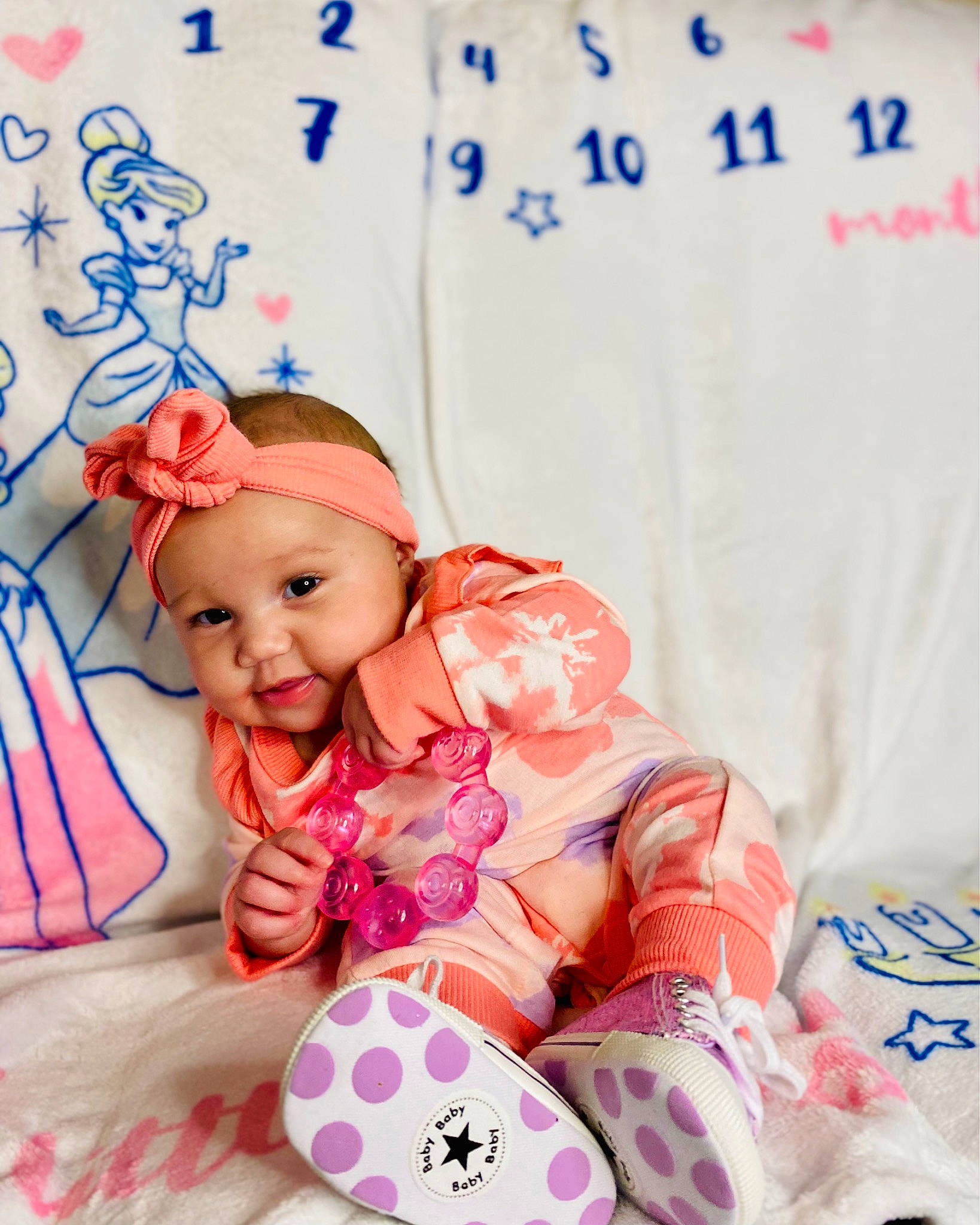 Amira is registered to the contest to win money with this photo: baby, baby_products, baby_toddler_clothing, child, comfort, fashion_accessory, font, happy, hat, headgear, headwear, linens, magenta, pattern, person, pink, skin, sleeve, smile, textile
