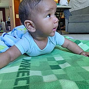 Jessie joined the competition — help win amazing prizes! baby, child, infant, blanket, minecraft, green, indoor, living_room, carpet, furniture, sofa, table, hat, curious, cute, toddler, person, portrait, home, casual