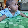 baby, child, infant, blanket, minecraft, green, indoor, living_room, carpet, furniture, sofa, table, hat, curious, cute, toddler, person, portrait, home, casual