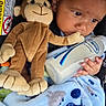 Jessie is registered to the contest to win money with this photo: baby, child, infant, bottle, milk, plush_toy, monkey_toy, blanket, car_seat, seatbelt, blue_blanket, soft_toy, person, closeup, face, hand, expression, indoors, sitting, cute