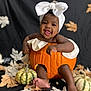 baby, pumpkin, bow, smiling, autumn, fall, leaves, gourds, cute, child, portrait, dark_background, decor, feet, hands, headwrap, orange, white, happy, seasonal