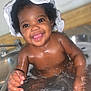 baby, bath, water, sink, smile, happy, child, curly_hair, towel, wet_skin, splashing, cute, indoors, playful, face, joyful, skin, person, closeup, toddler