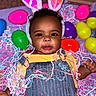 Myla joined the competition — help win amazing prizes! baby, child, bunny_ears, denim_overalls, yellow_shirt, easter_eggs, colorful, confetti, celebration, playful, cute, smiling, indoor, portrait, festive, holiday, toy, happy, person, infant