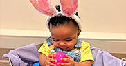 Myla joined the competition — help win amazing prizes! baby, basket, bunny_ears, celebration, child, colorful, curious, cute, denim_overalls, easter_eggs, floor, hands, holiday, indoor, infant, playful, purple_blanket, smiling, toys, yellow_shirt