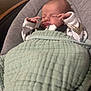 baby, newborn, infant, sleeping, blanket, bouncer, hands, face, cozy, mint_green, gray_cushion, indoors, portrait, soft_texture, clothing, peaceful, resting, tiny_hands, cute, nursery