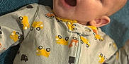 Joshua joined the competition — help win amazing prizes! baby, infant, onesie, vehicle_pattern, cars, surprised, mouth_open, blue_blanket, lying_down, portrait, close_up, cute, expressive, fabric, ear, eyes, sleepwear, zipper, soft_texture, infant_garment
