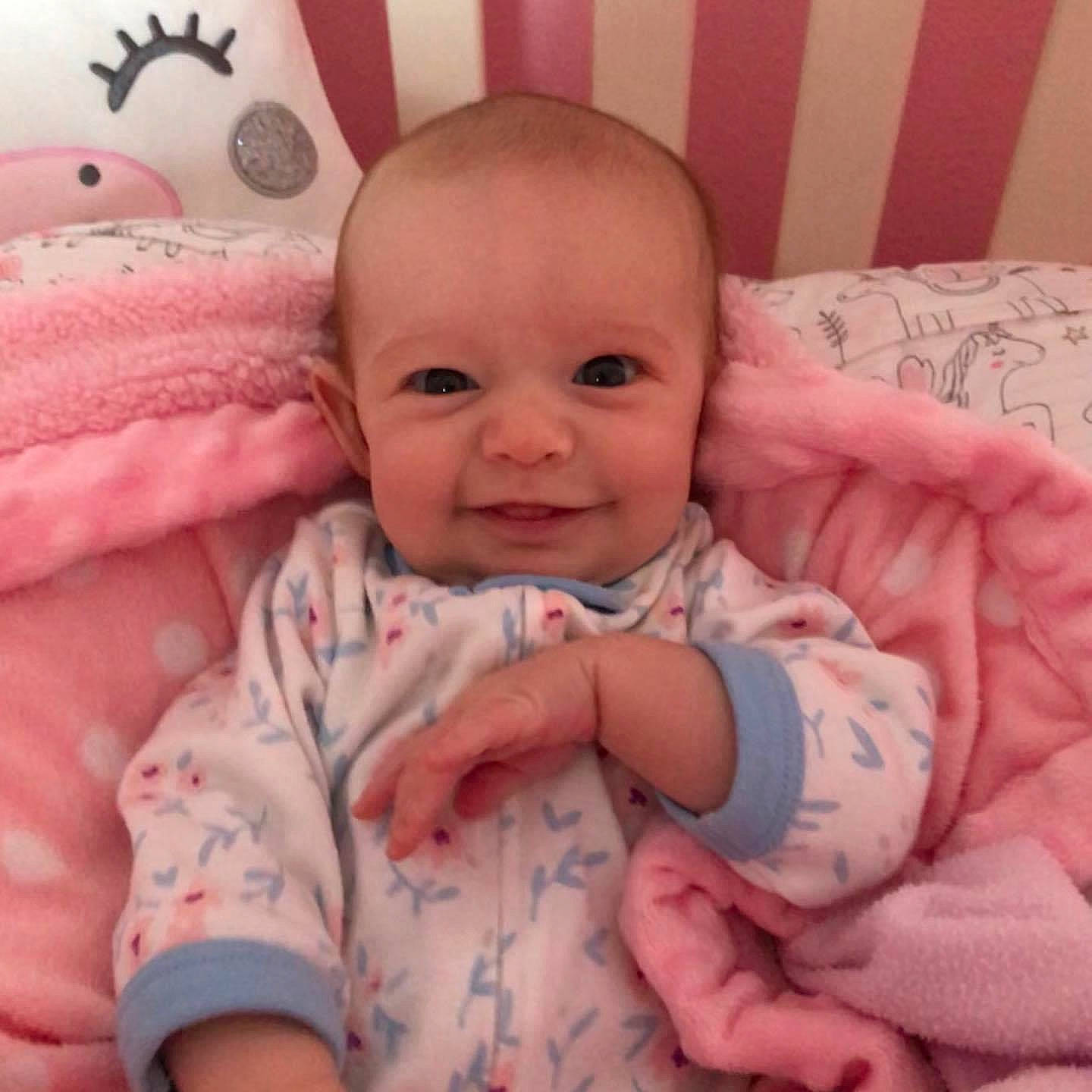 Erin is registered to the contest to win money with this photo: baby, baby_making_funny_faces, beauty, cheek, child, eye, face, facial_expression, finger, hand, head, iris, joy, lip, mouth, nose, person, pink, skin, smile