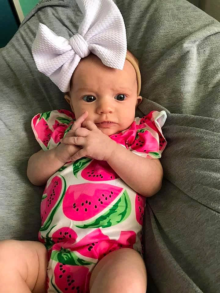 Erin is registered to the contest to win money with this photo: baby, baby_products, baby_toddler_clothing, cheek, child, finger, hair_accessory, hand, headgear, person, pink, product, skin, toddler
