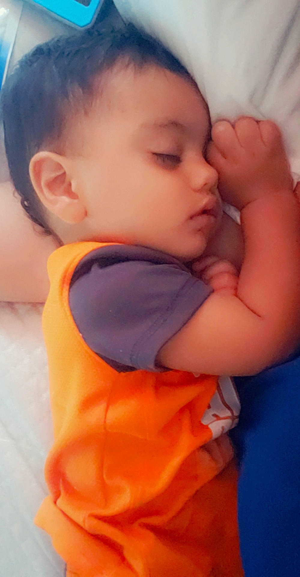 Fernando is registered to the contest to win money with this photo: arm, baby, cheek, child, chin, eye, face, finger, forehead, hand, head, lip, mouth, muscle, neck, nose, orange, person, skin, sleep