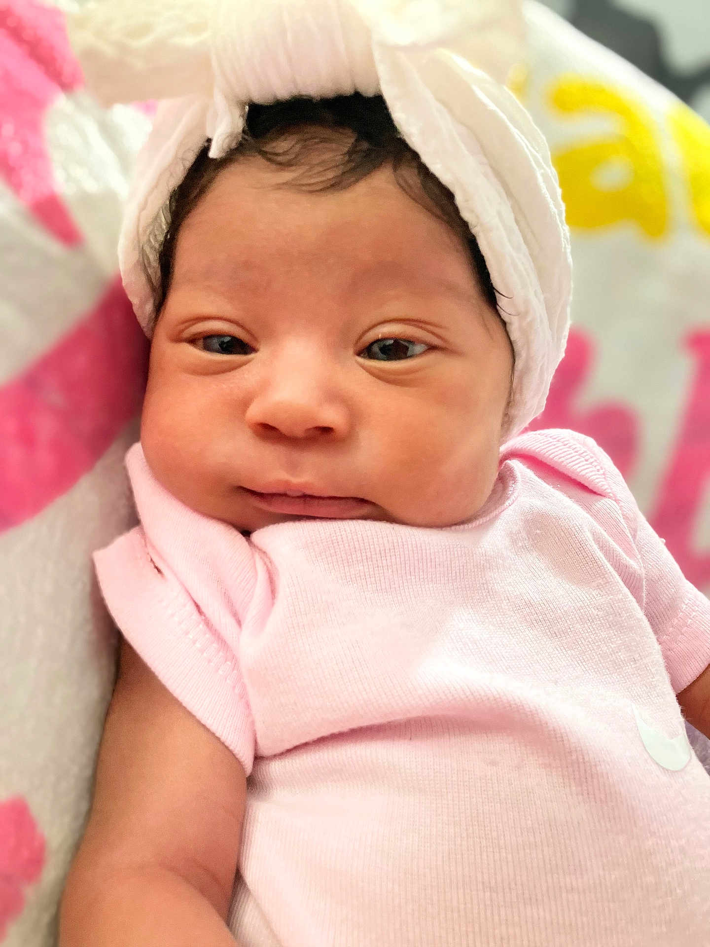 Kehlani is registered to the contest to win money with this photo: baby, infant, pink_clothing, white_towel, face, portrait, sleepy, soft_texture, blanket, close_up, newborn, cute, skin, headwear, child, resting, indoors, calm, young, person