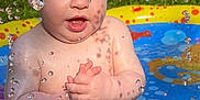 River joined the competition — help win amazing prizes! baby, bare_chest, child, clothing, daytime, fence, fun, grass, happy, outdoor, play, pool, shorts, sitting, splash, summer, sunlight, toddler, water, water_droplets