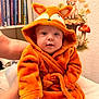 River joined the competition — help win amazing prizes! baby, child, orange_robe, fox_hood, cute, indoor, nursery, bookshelf, wall_decal, rabbit, mushrooms, soft_fabric, portrait, person, infant, smiling, hand, bed, cozy, curious