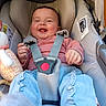 Ava a rejoint le concours — aidez-le/la à gagner de superbes lots ! baby, car_seat, child, smiling, happy, plush_toy, clothing, blue_pants, striped_sweater, seatbelt, infant, cute, indoor, safety_harness, person, joyful, portrait, young_child, head, hand