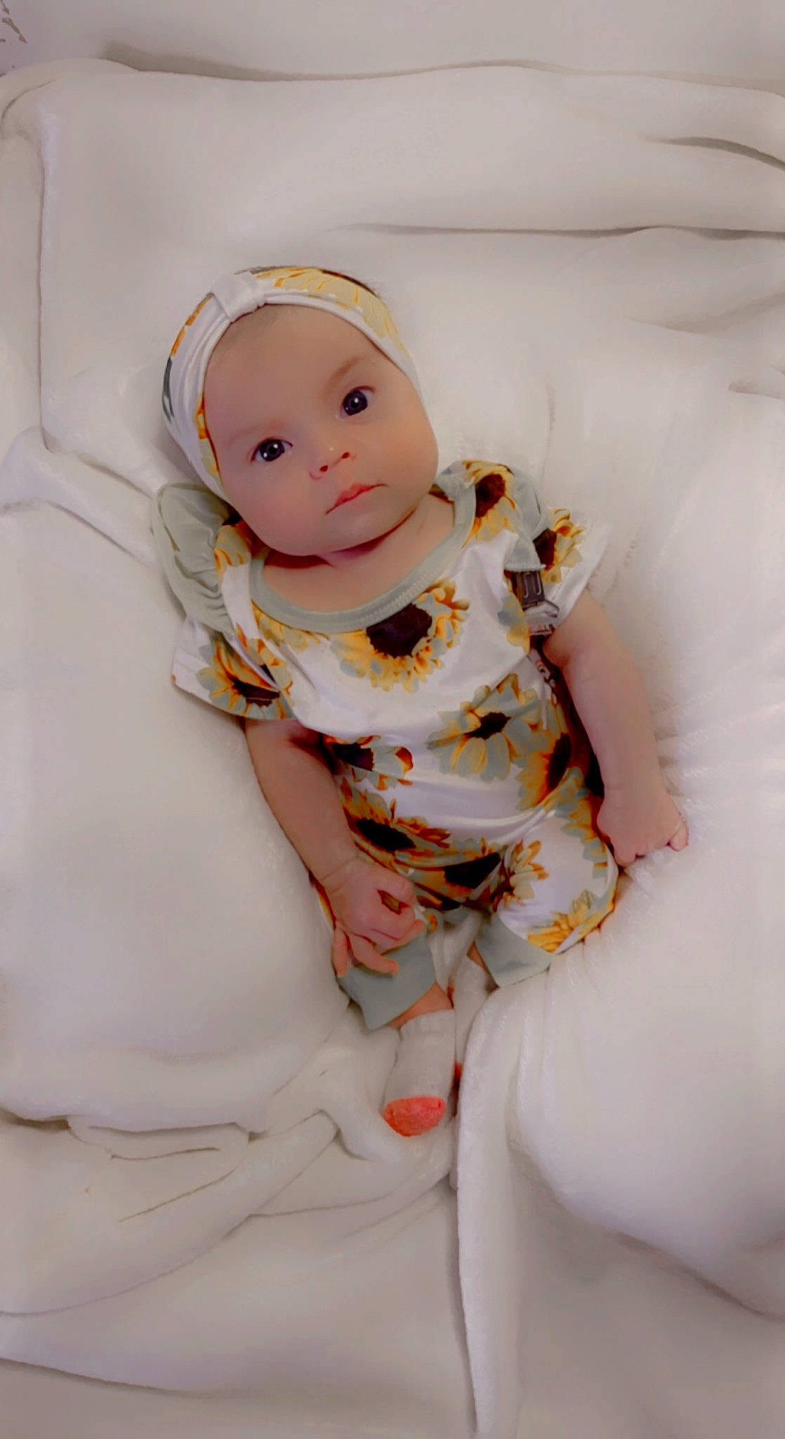 Hazley Conrad is registered to the contest to win money with this photo: baby, baby_toddler_clothing, baby_toys, child, comfort, doll, eyelash, figurine, linens, one_piece_garment, peach, person, sitting, sleeve, toy