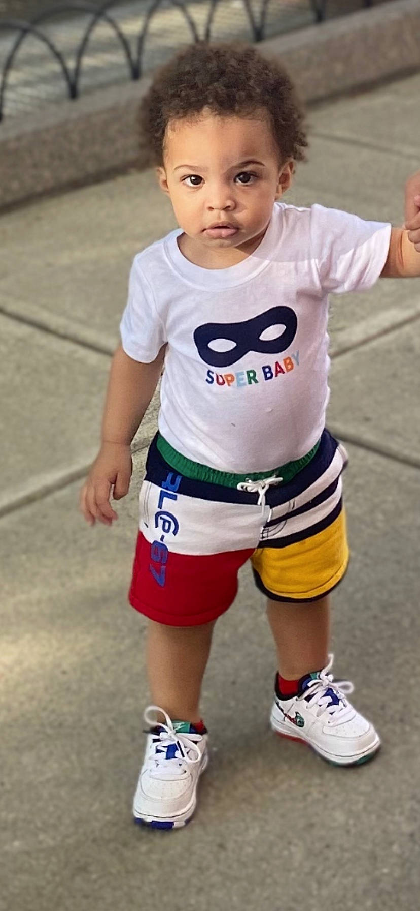 Cleo is registered to the contest to win money with this photo: active_shorts, arm, athletic_shoe, baby_toddler_clothing, calf, cheek, child, cool, hand, human_leg, joint, knee, leg, mouth, person, shoe, shorts, sleeve, sneakers, standing