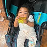 Mylanii is registered to the contest to win money with this photo: baby, black_socks, car_seat, child, clothing, curly_hair, cute, face, flooring, hand, indoor, infant, looking, minnie_mouse, pants, sitting, striped, teether, toy, wood_floor