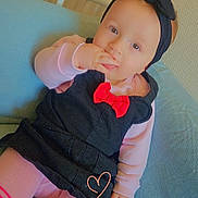 éva a rejoint le concours — aidez-le/la à gagner de superbes lots ! baby, child, infant, headband, black_dress, red_bow, pink_tights, striped_tights, cushion, blue_cushion, hand, fingers, sitting, indoor, portrait, cute, innocent, soft_lighting, cozy, young