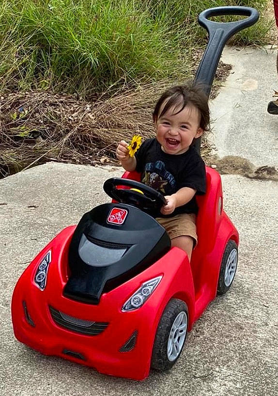 Malakhi joined the competition — help win amazing prizes! automotive_design, car, child, city_car, driving, fun, grass, motor_vehicle, person, plant, red, smile, toddler, vacation, vehicle