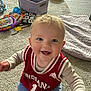 baby, child, smiling, indiana, jersey, basketball, carpet, toys, blanket, indoor, happy, cute, sitting, playtime, infant, person, clothing, floor, home, portrait