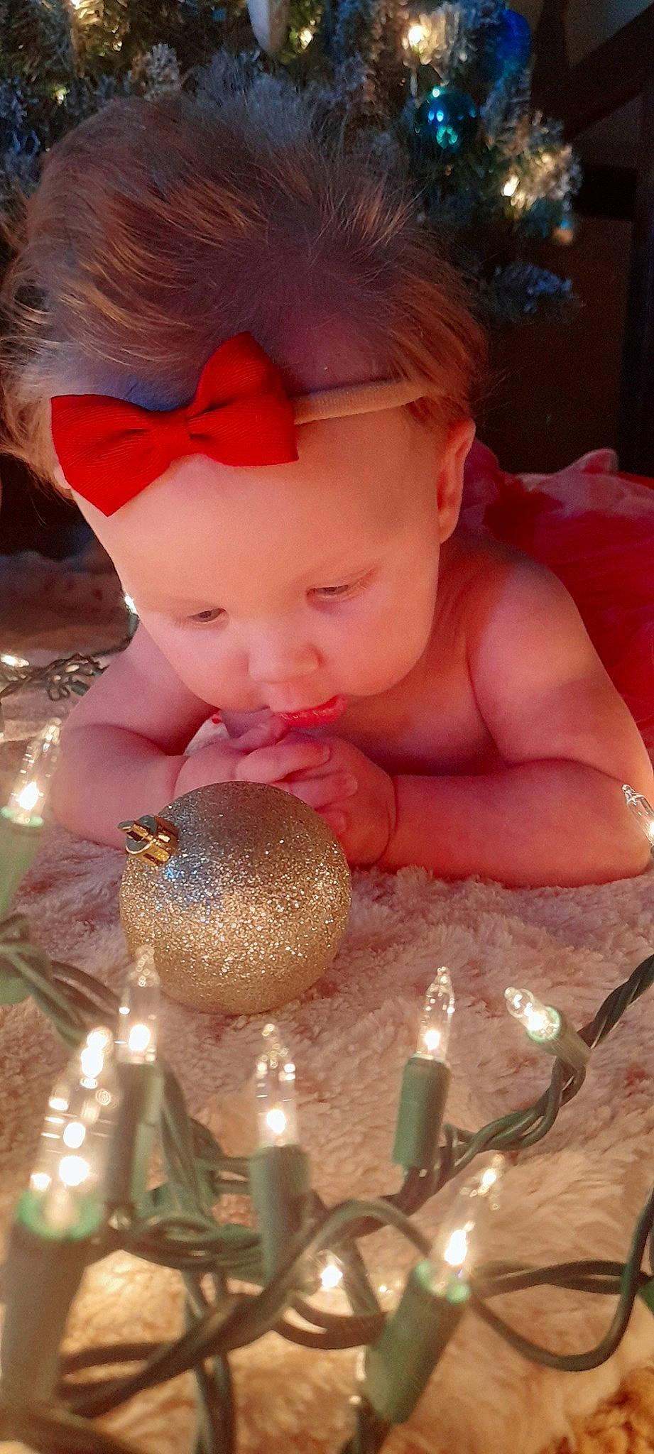 Layne is registered to the contest to win money with this photo: baby, bathing, cap, child, christmas_ornament, cutlery, drinkware, event, fashion_accessory, fun, glass, happy, holiday, kitchen_utensil, nail, ornament, person, pink, stemware, tableware