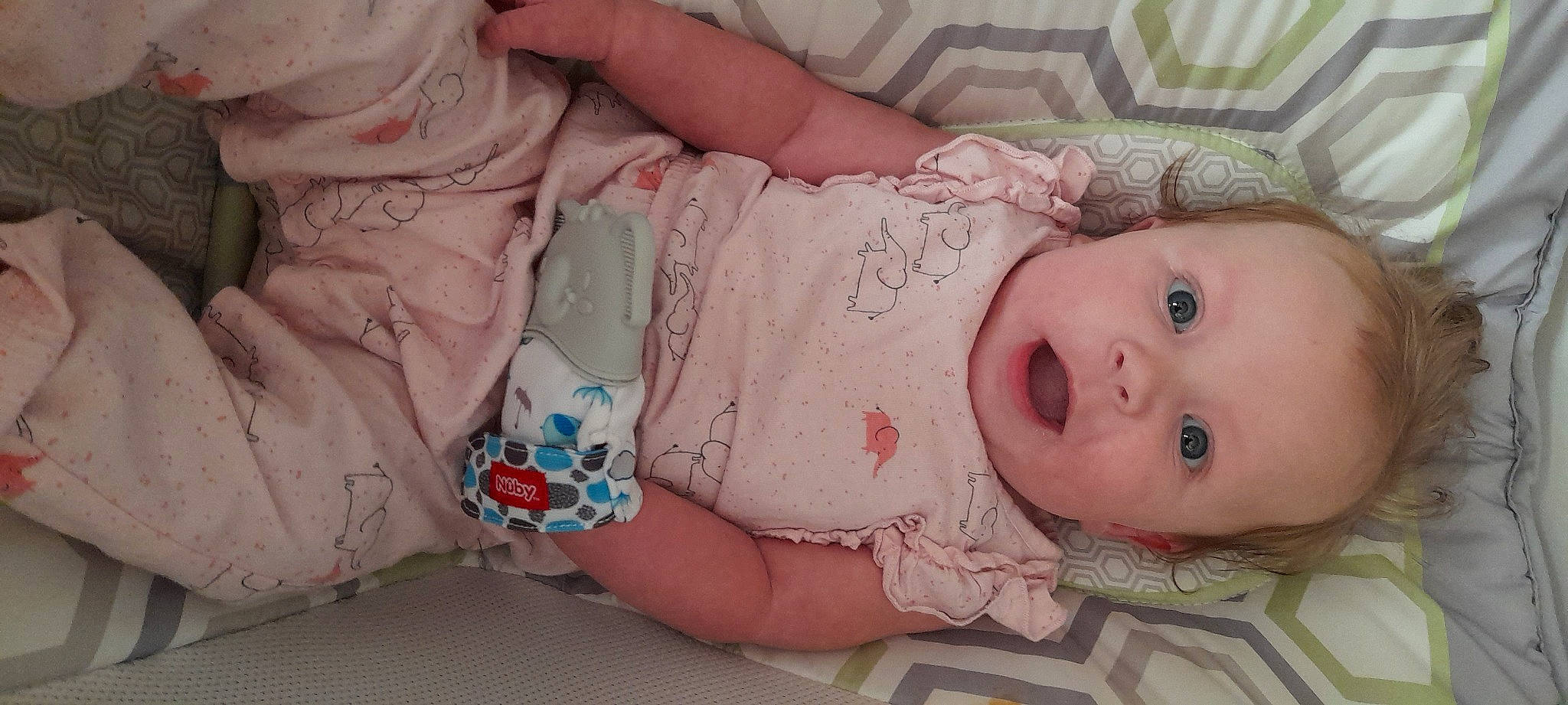 Layne is registered to the contest to win money with this photo: arm, baby, baby_toddler_clothing, cheek, child, eye, eyelash, hand, headgear, human_body, iris, linens, lip, mouth, nose, pattern, person, pink, skin, sleeve