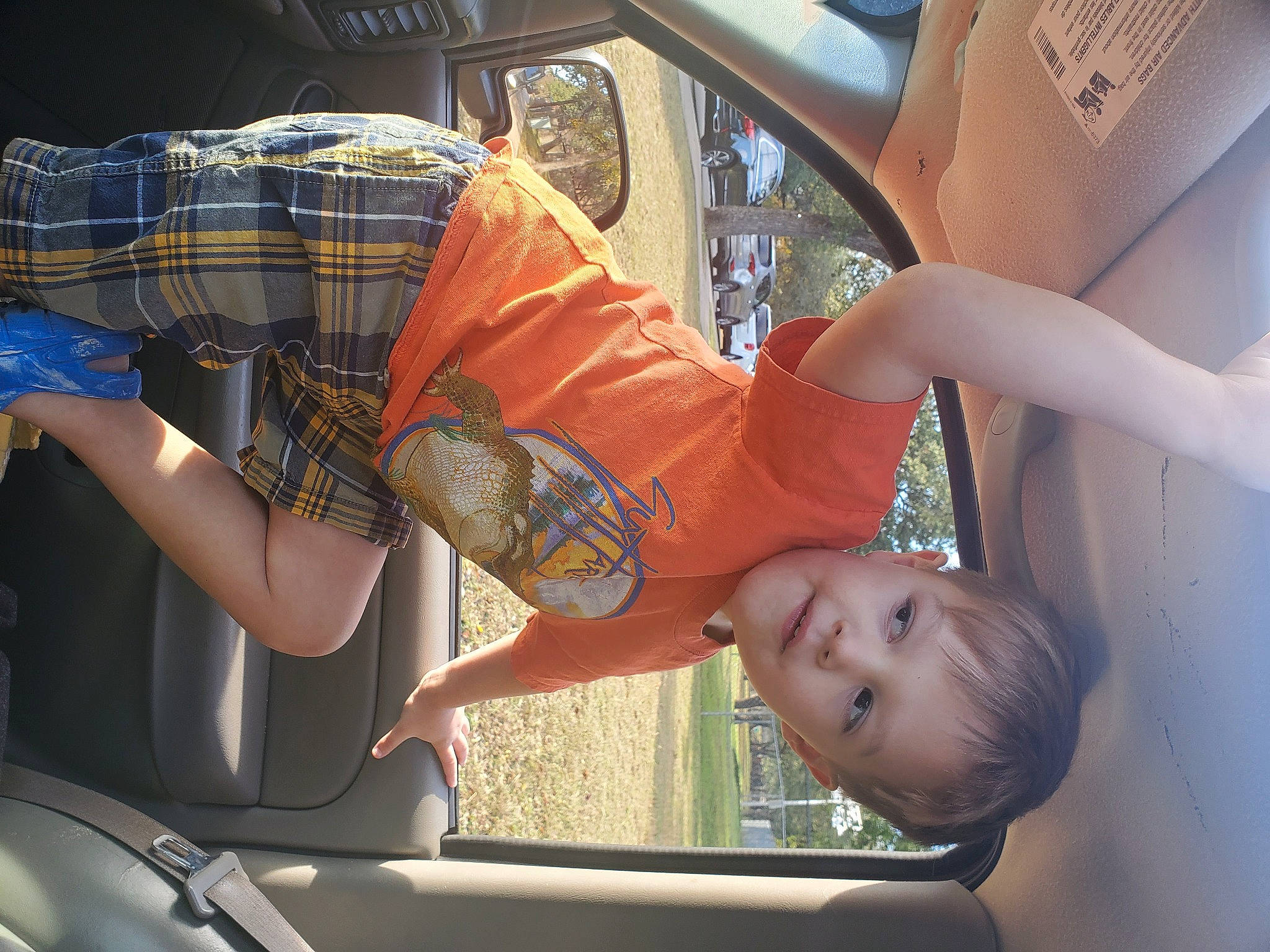 Garrett is registered to the contest to win money with this photo: auto_part, automotive_design, automotive_exterior, automotive_lighting, automotive_window_part, car, finger, fun, gesture, glass, hood, human_leg, motor_vehicle, person, tartan, tints_and_shades, toddler, vehicle, vehicle_door, window