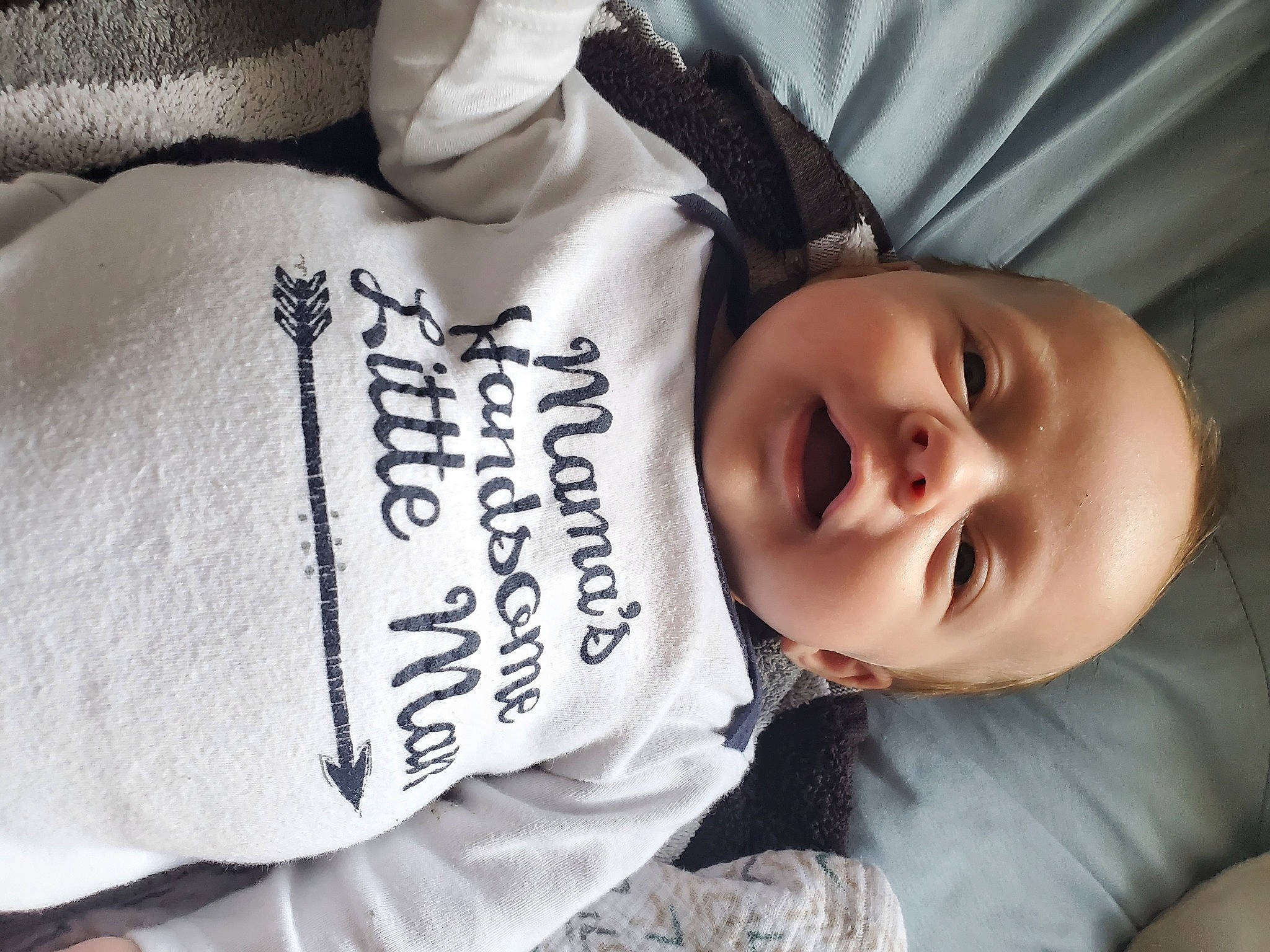 Gentry is registered to the contest to win money with this photo: comfort, face, facial_expression, flash_photography, grey, hairstyle, hand, happy, head, mammal, neck, outerwear, person, plant, product, skin, sleeve, smile, textile, vertebrate