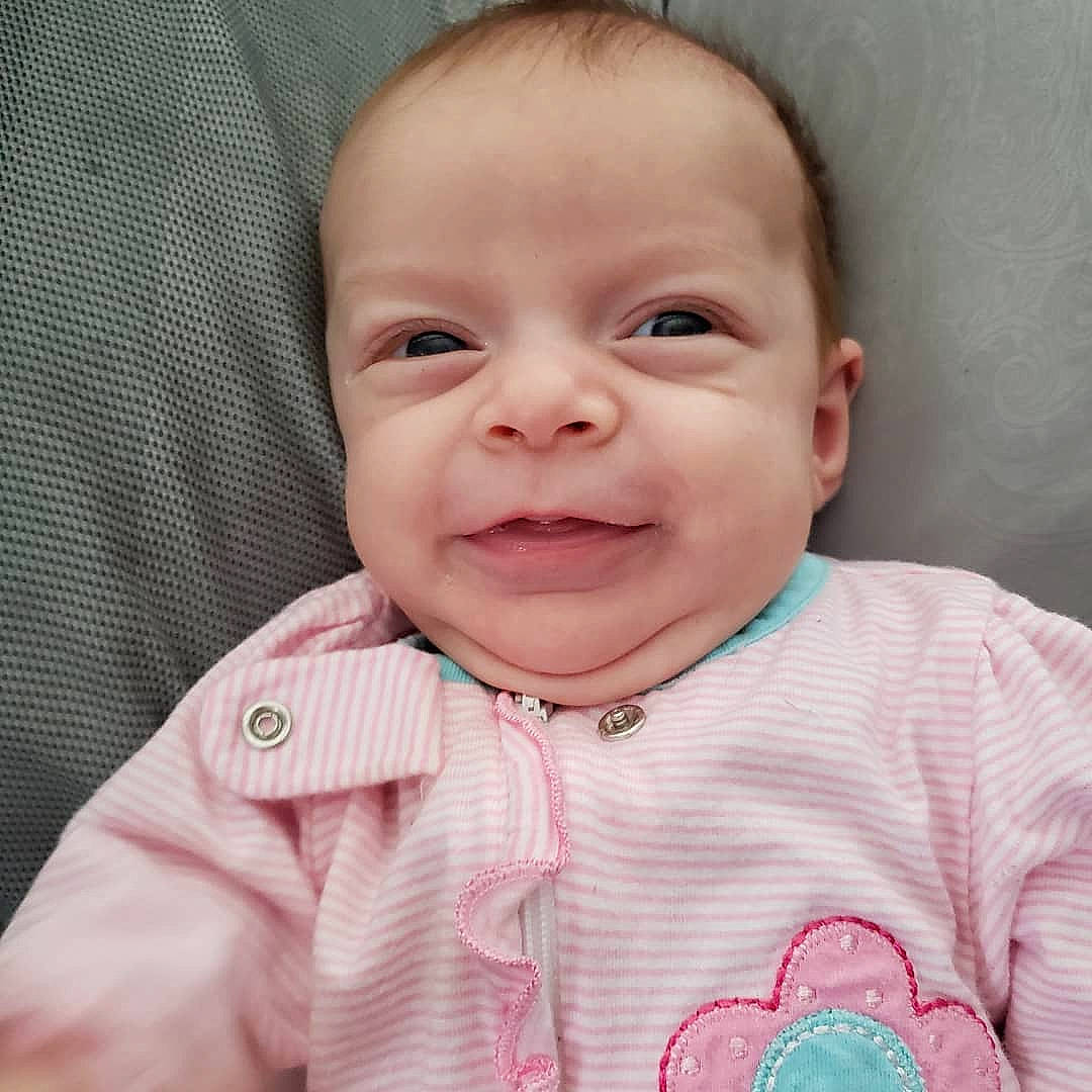 Ava is registered to the contest to win money with this photo: baby, baby_making_funny_faces, cheek, child, chin, close_up, eye, face, facial_expression, forehead, happy, head, iris, lip, mouth, nose, person, pink, skin, smile