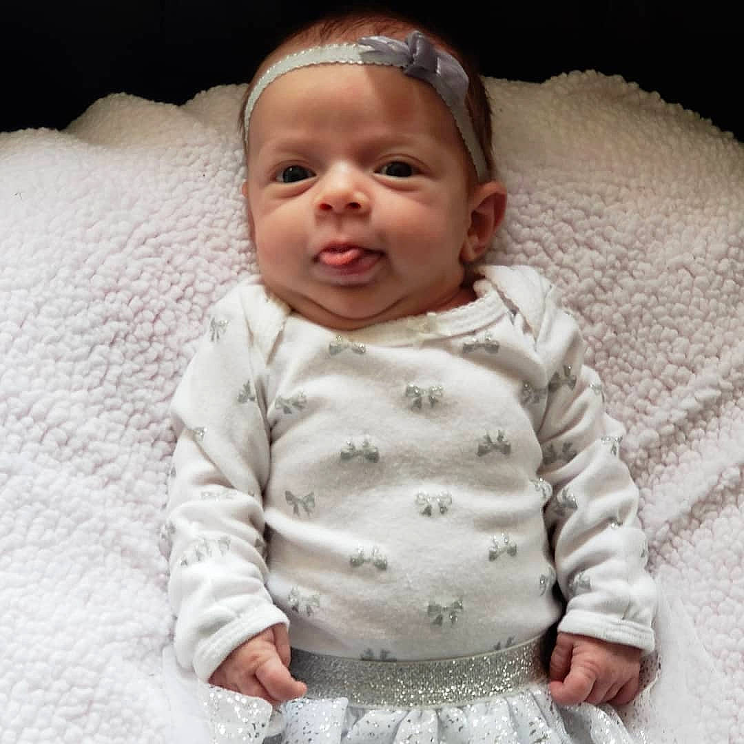 Ava joined the competition — help win amazing prizes! baby, baby_toddler_clothing, cheek, child, face, forehead, head, nose, outerwear, person, sitting, skin, sleeve, smile, toddler