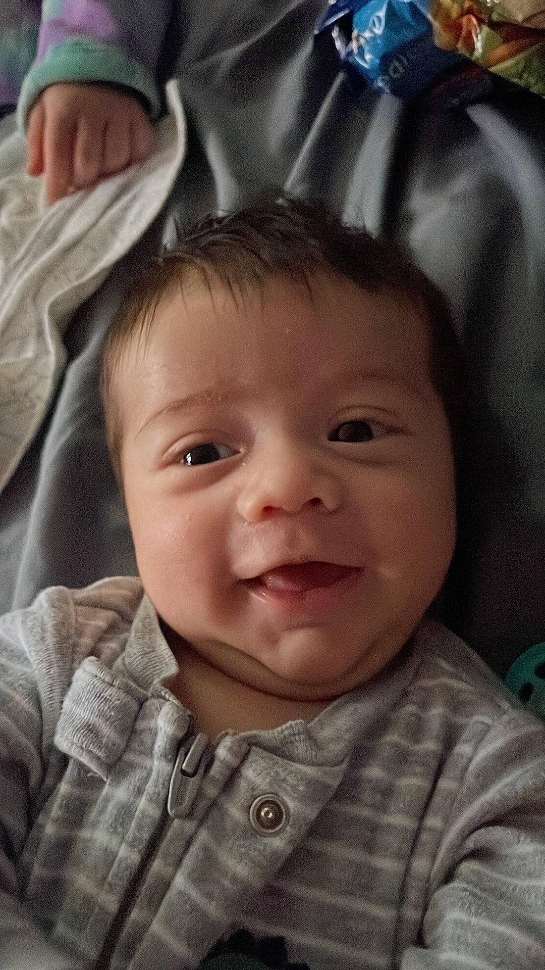 Julian is registered to the contest to win money with this photo: baby, baby_toddler_clothing, cheek, chin, comfort, eye, eyebrow, eyelash, face, gesture, happy, iris, lip, mouth, nose, person, skin, sleeve, smile, textile