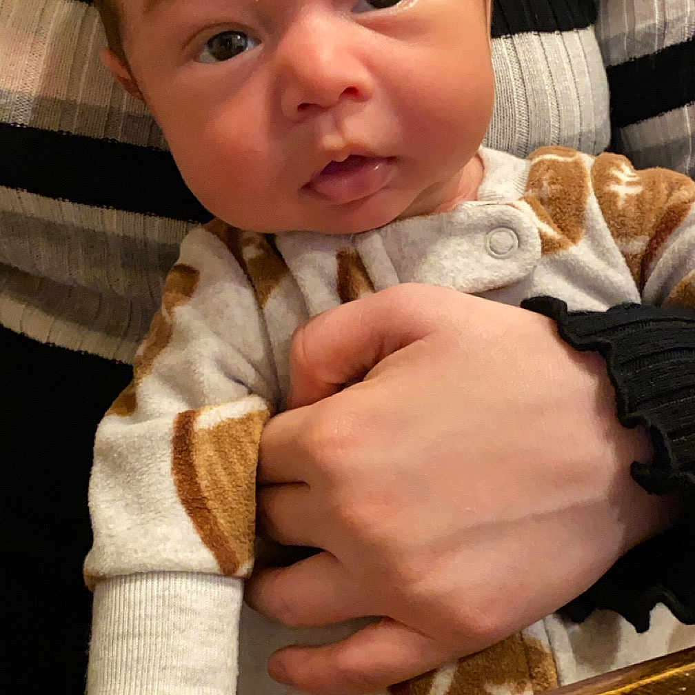 Jahkari is registered to the contest to win money with this photo: baby, bodypart, clothing, crib, face, finger, furniture, hand, hardwood, head, infantbed, knitwear, newborn, person, photography, plywood, portrait, sitting, sweater, wood